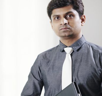 Portrait of serious Indian lawyer with leather folder